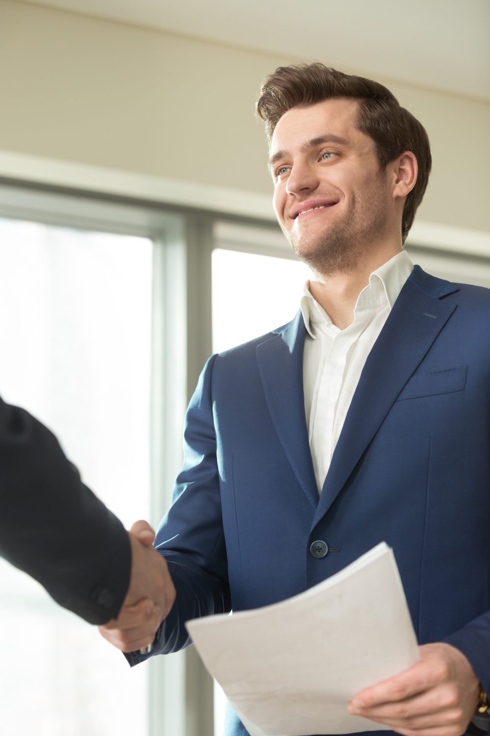 smiling man handshaking with client